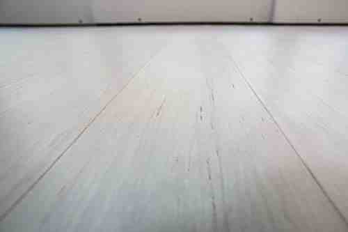 How do you cut laminate flooring against a wall?