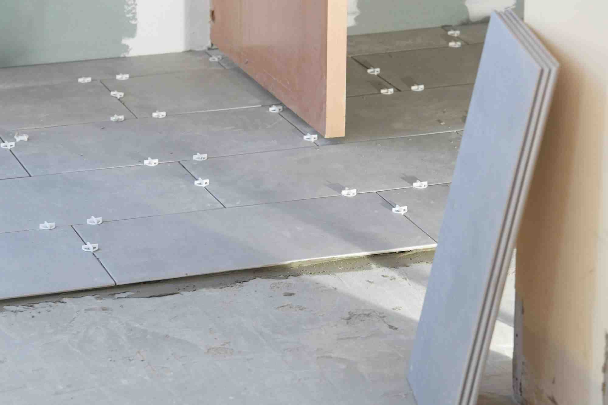 Does flooring go under kitchen cabinets?